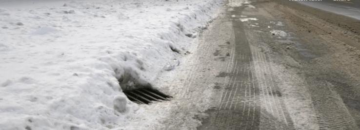 Snow covered road with salt on it