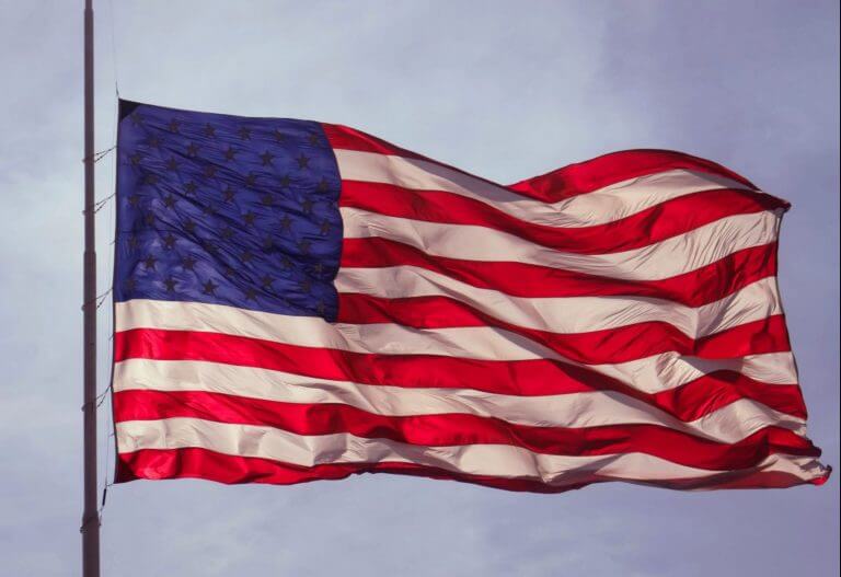 american flag waving at half staff