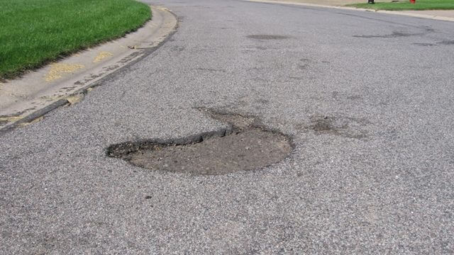 pothole in the middle of a street