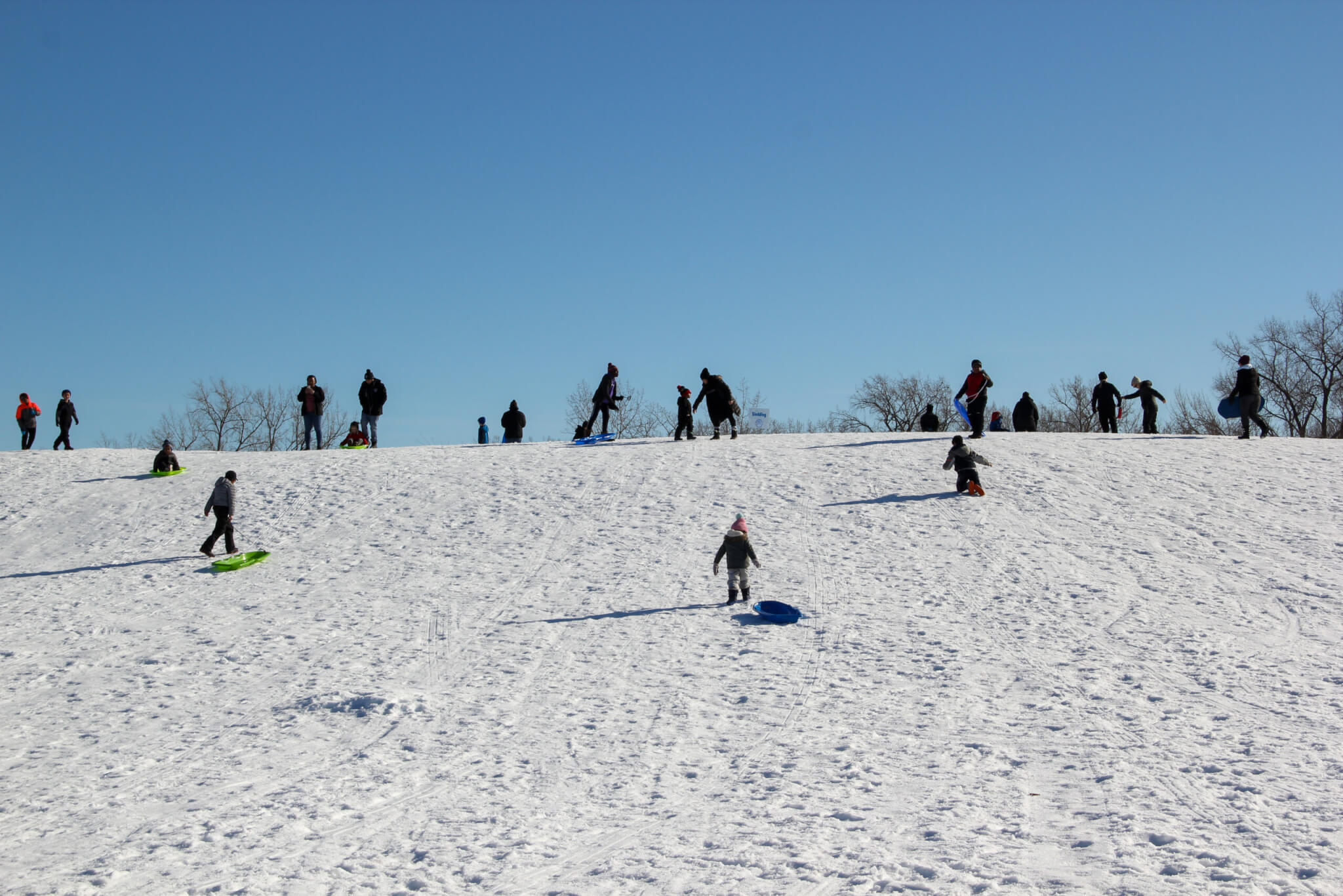 People sledding on a hill