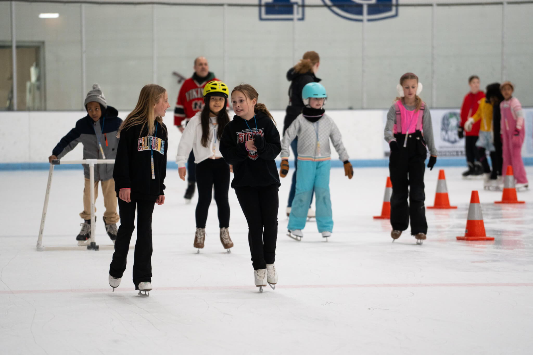 Photo of people ice skating on an indoor rink