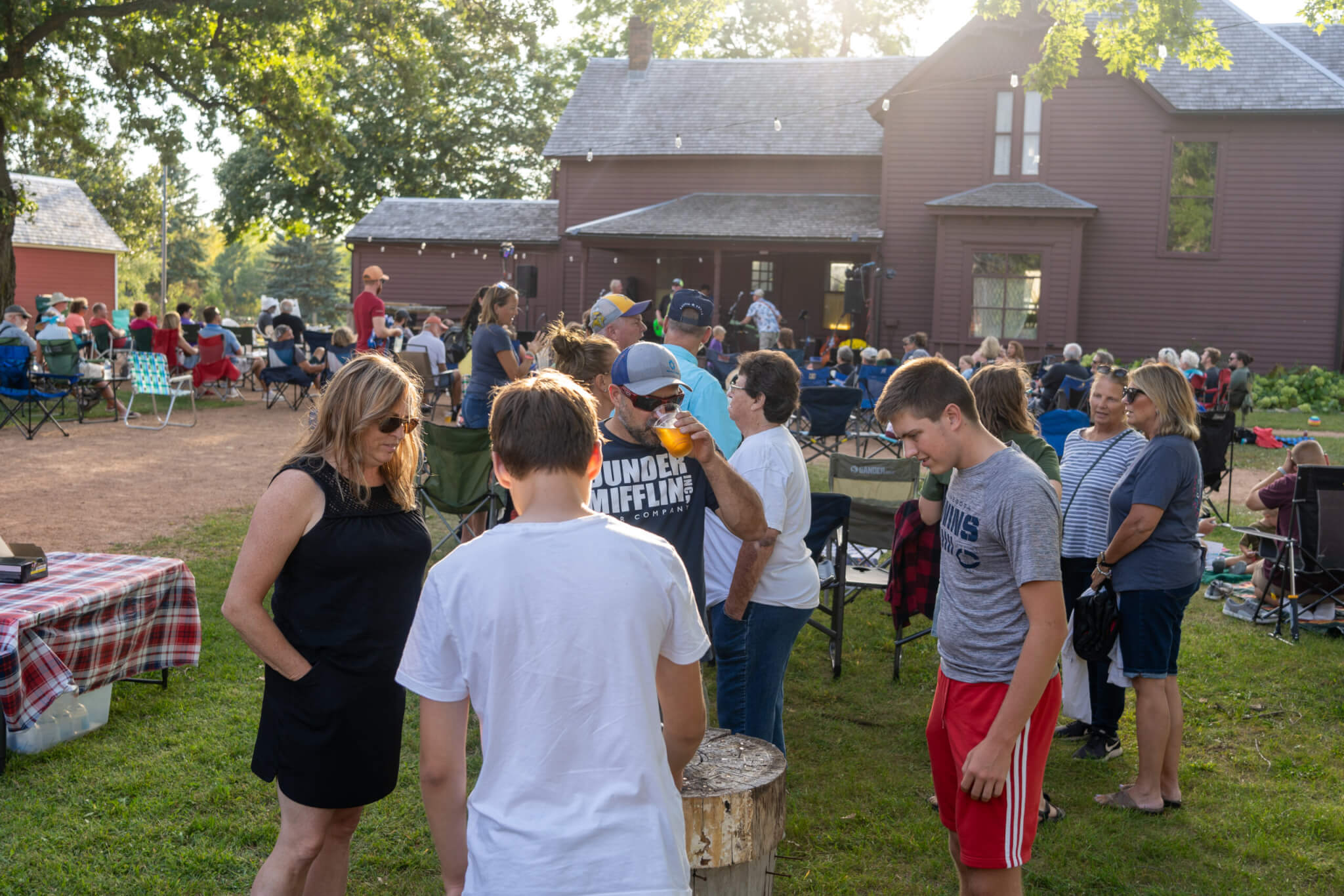 People at a farm, listening to music and enjoying a happy hour