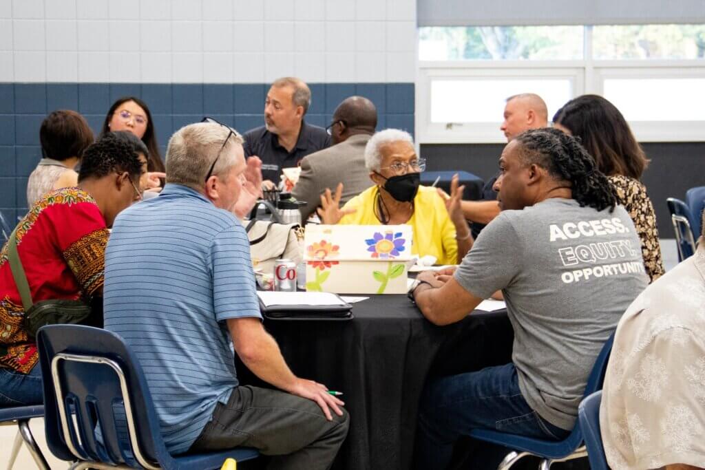 Community members sitting around a table sharing their vision for Brooklyn Park at one of our community engagement events.